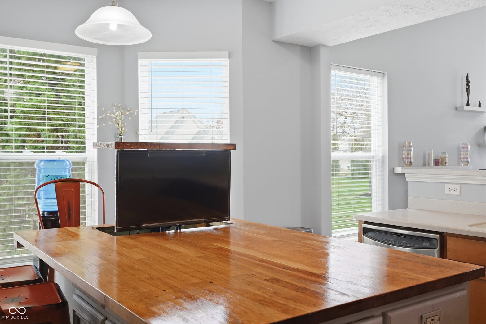 Bright living area with fireplace and abundant natural light.