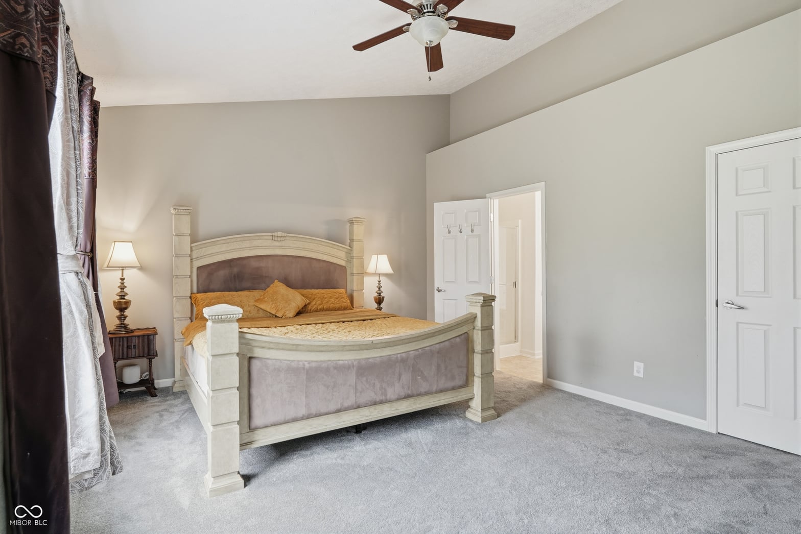 Spacious primary bedroom with attached bathroom access.