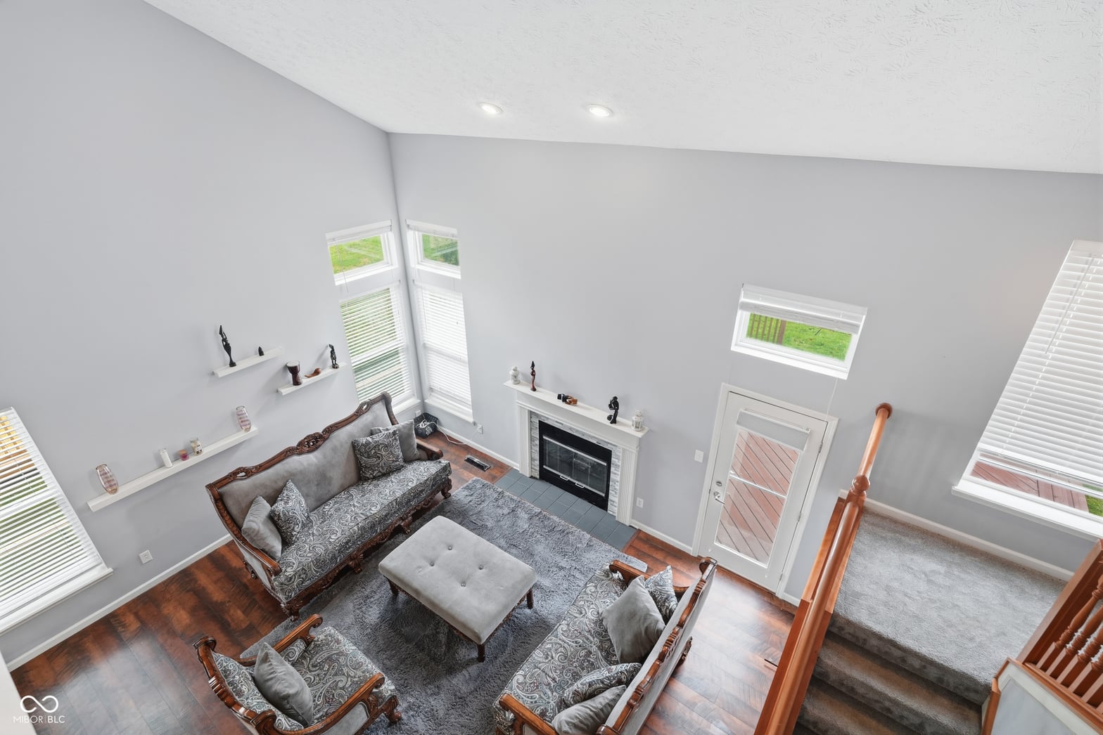 Bright, modern family room with vaulted ceilings and fireplace.
