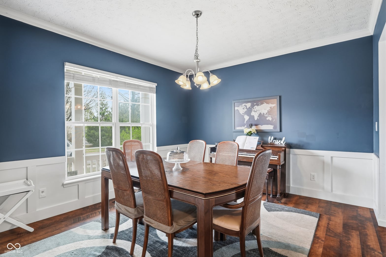 Elegant dining room with wainscoting and French doors.