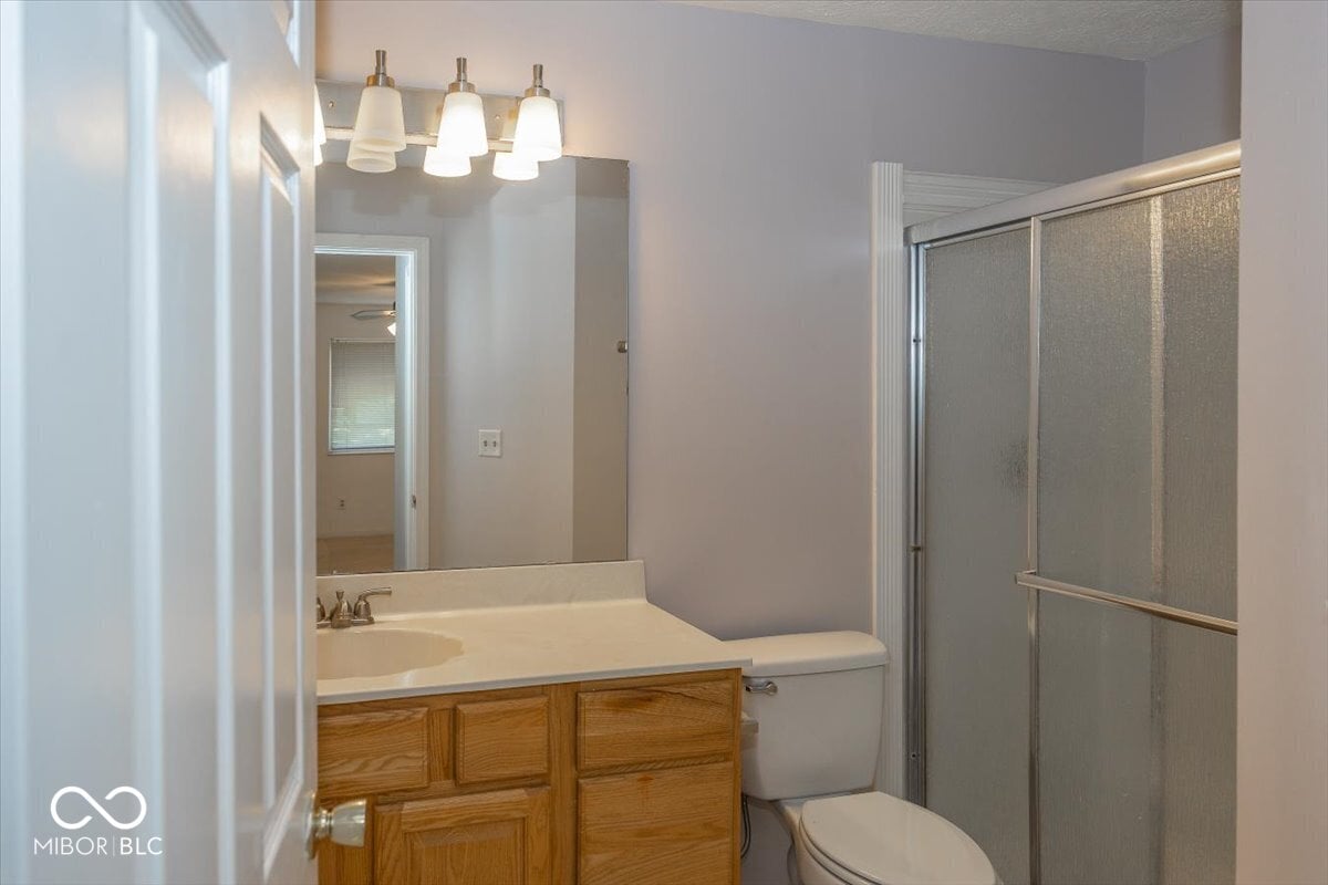 Spacious primary bath with vanity and walk-in shower.