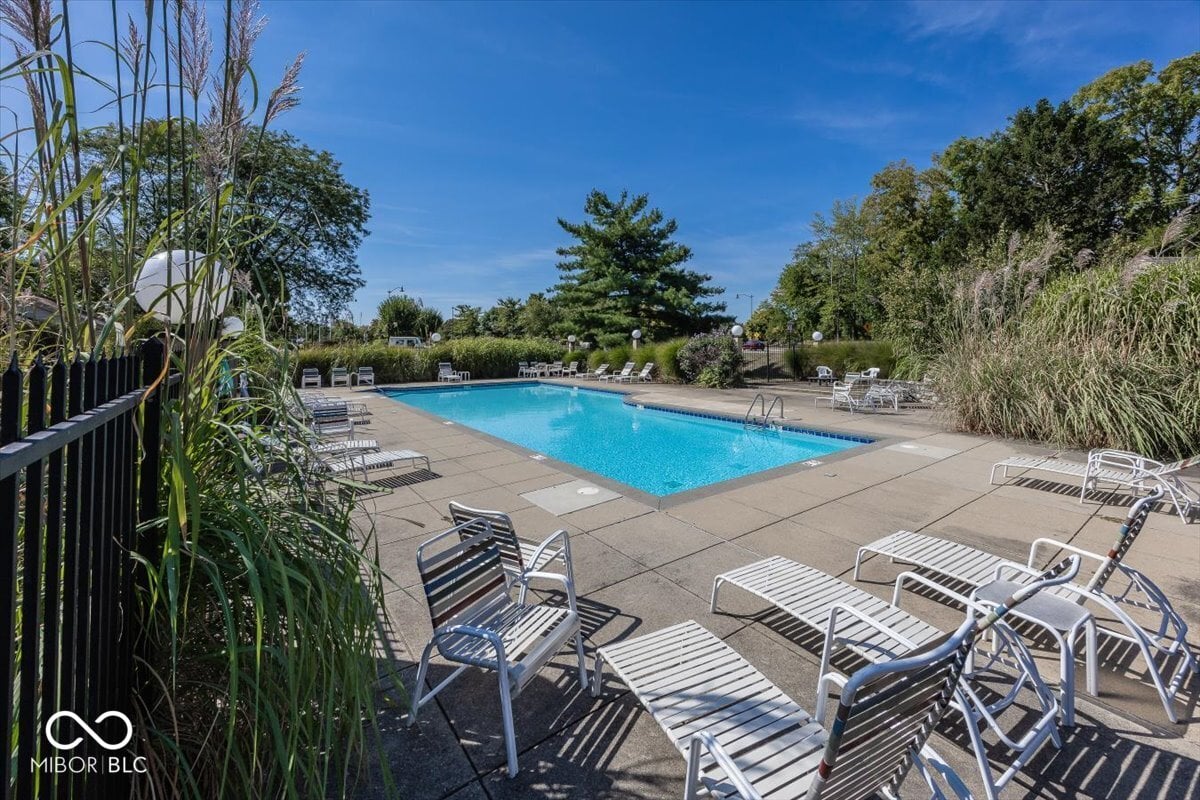 Resort-style pool with ample lounge seating and landscaping.