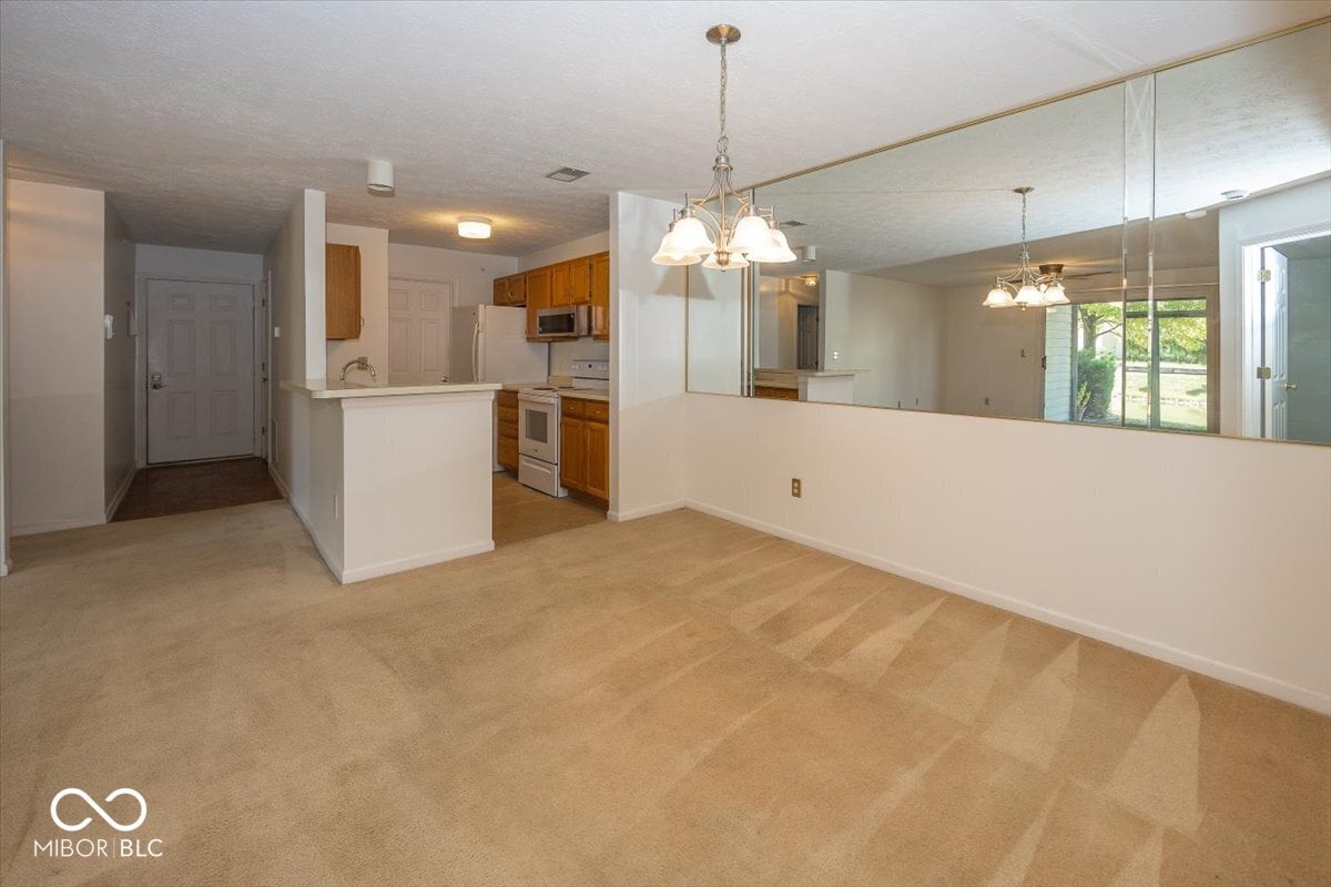 Open kitchen with breakfast bar and natural light.