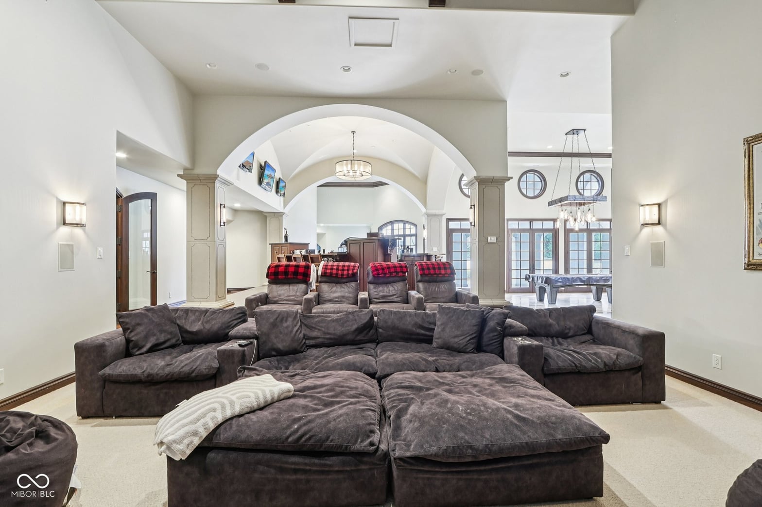 Luxurious barrel vault family room with home theater seating.