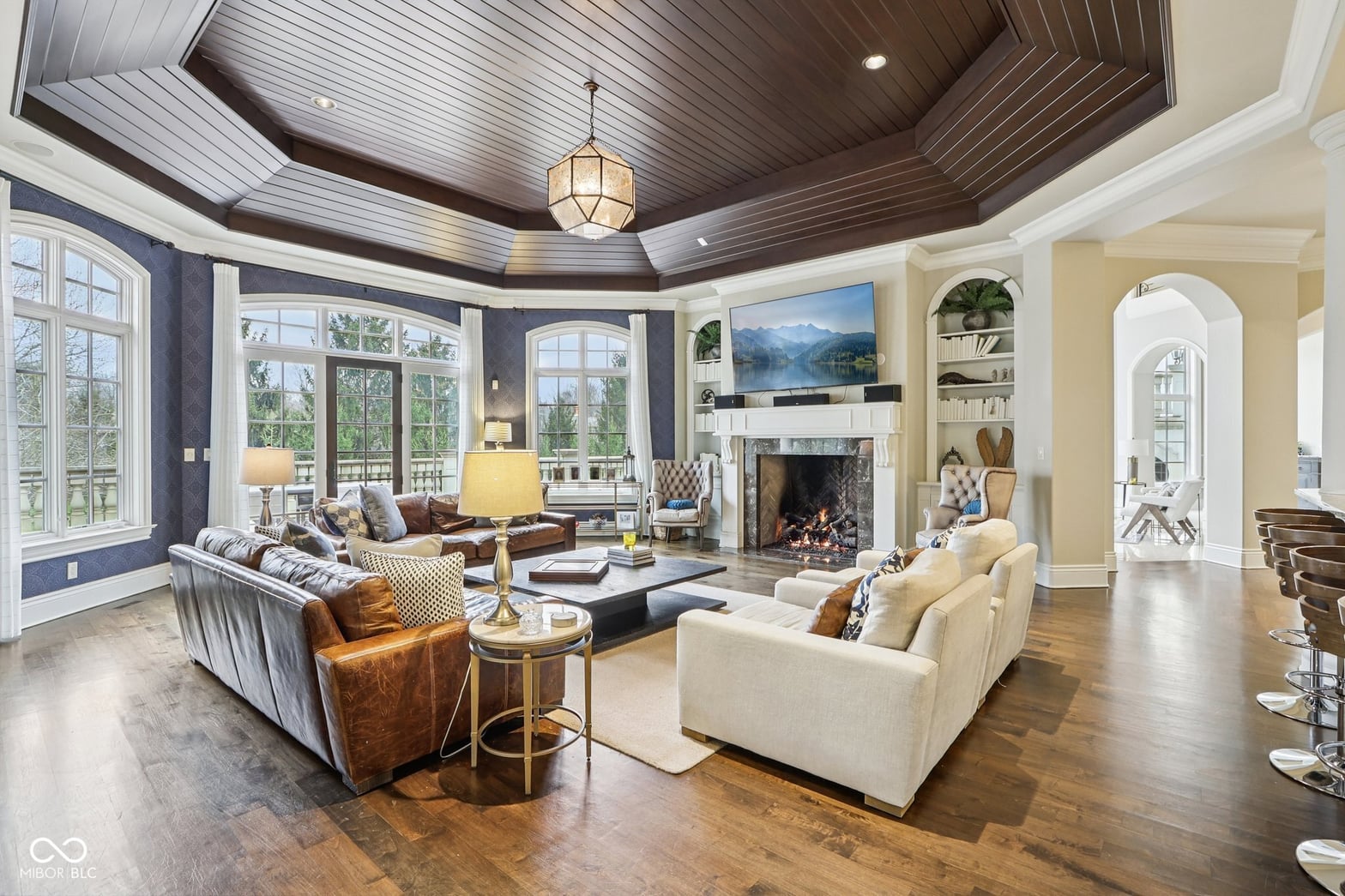 Sophisticated living room with fireplace and coffered ceiling.