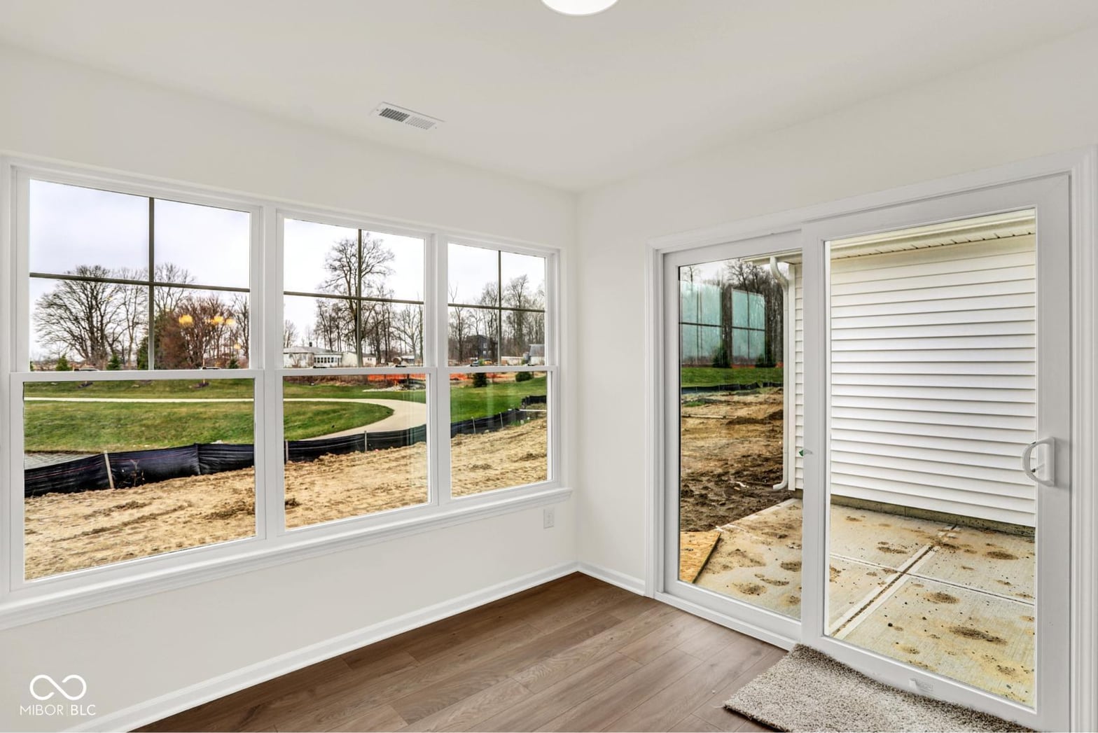 Outdoor living area at 19418 Atwater Avenue, Sheridan, IN — Bright sunroom with expansive windows and pastoral views.