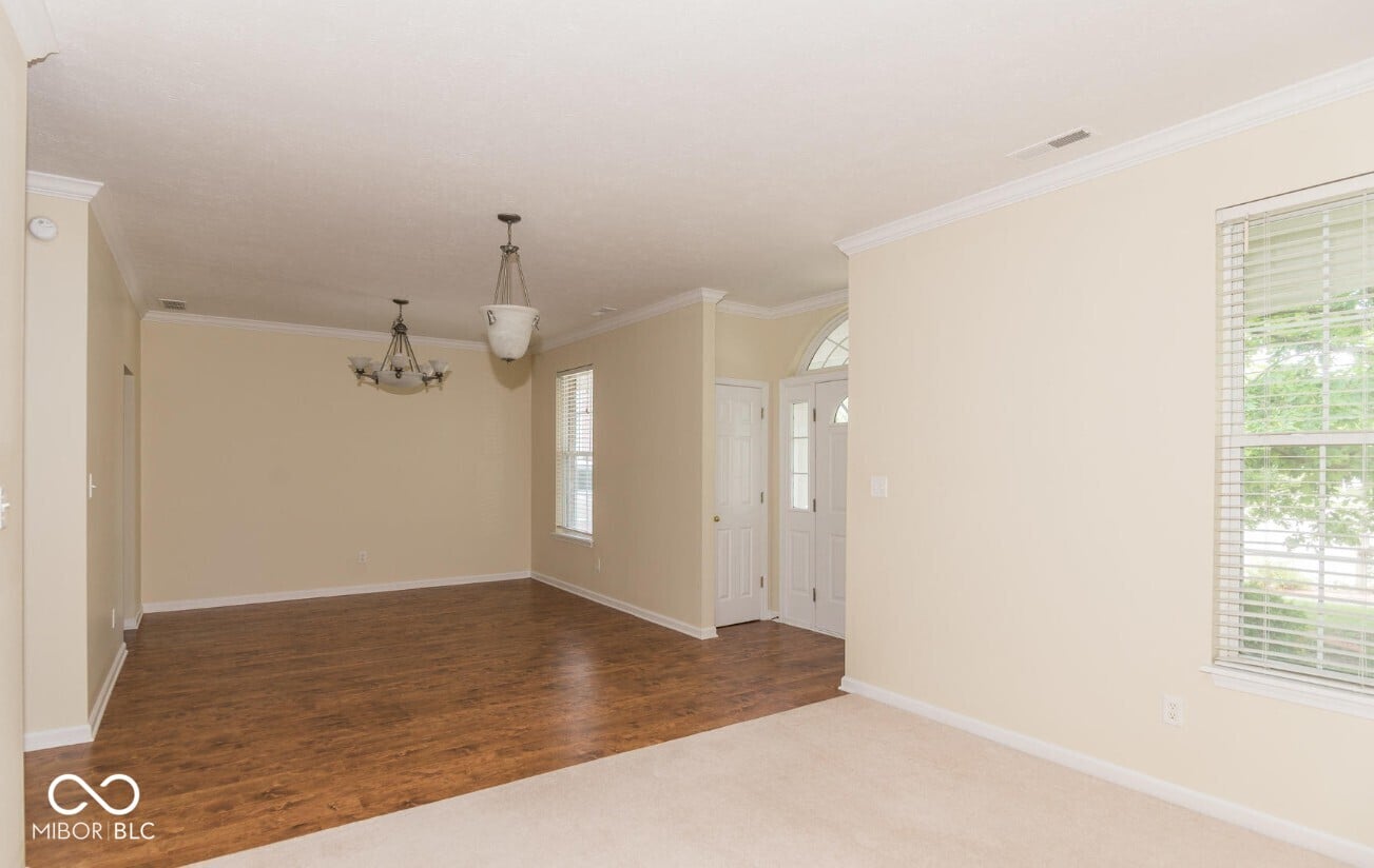 Spacious living room with hardwood floors and abundant natural light.