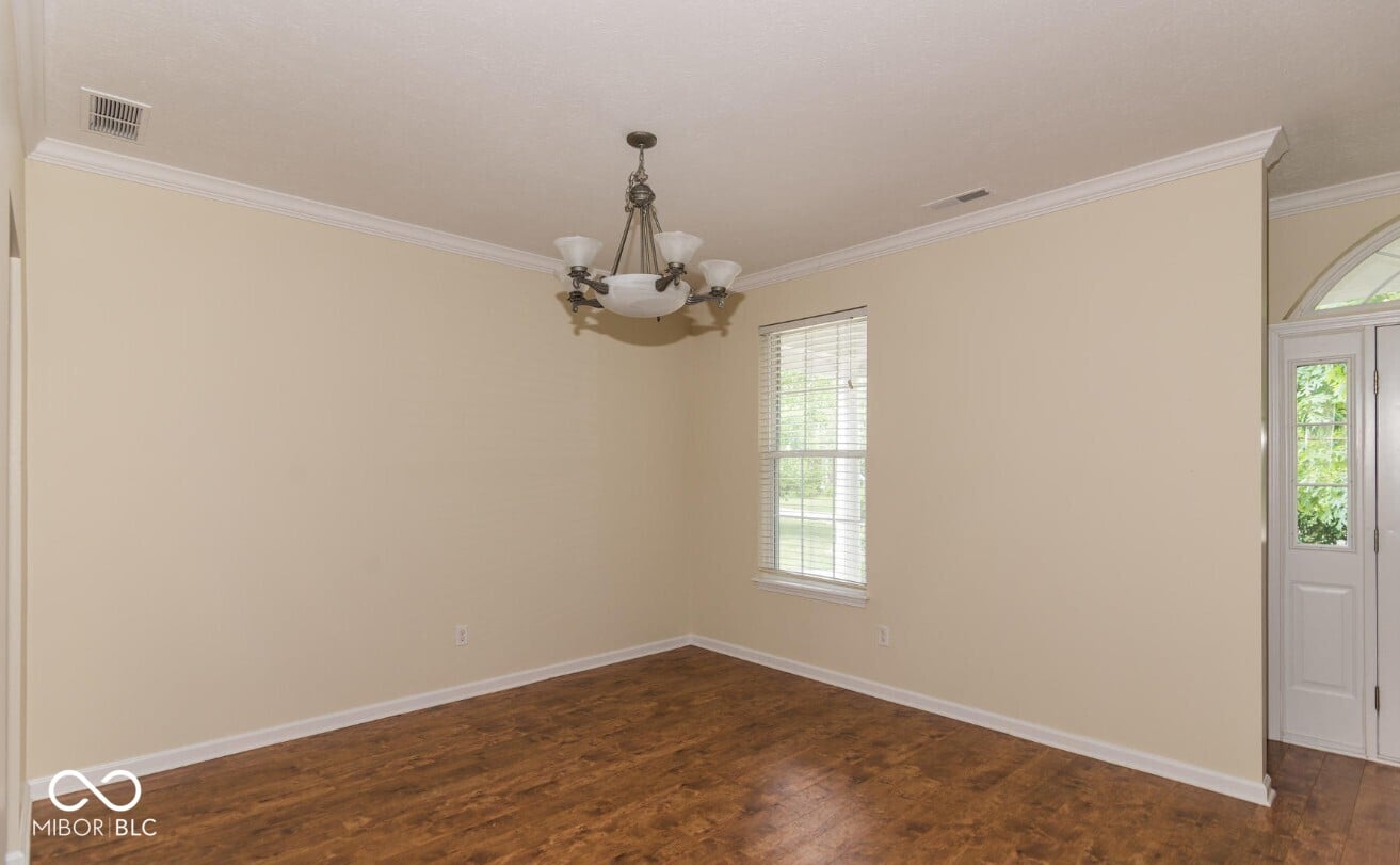 Elegant dining room with hardwood floors and natural light.