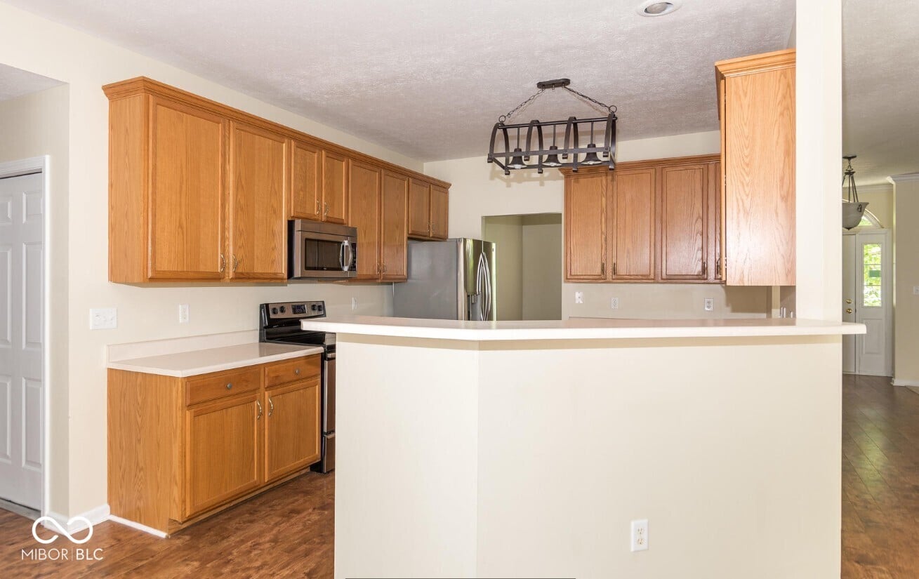 Spacious kitchen with oak cabinets and island.