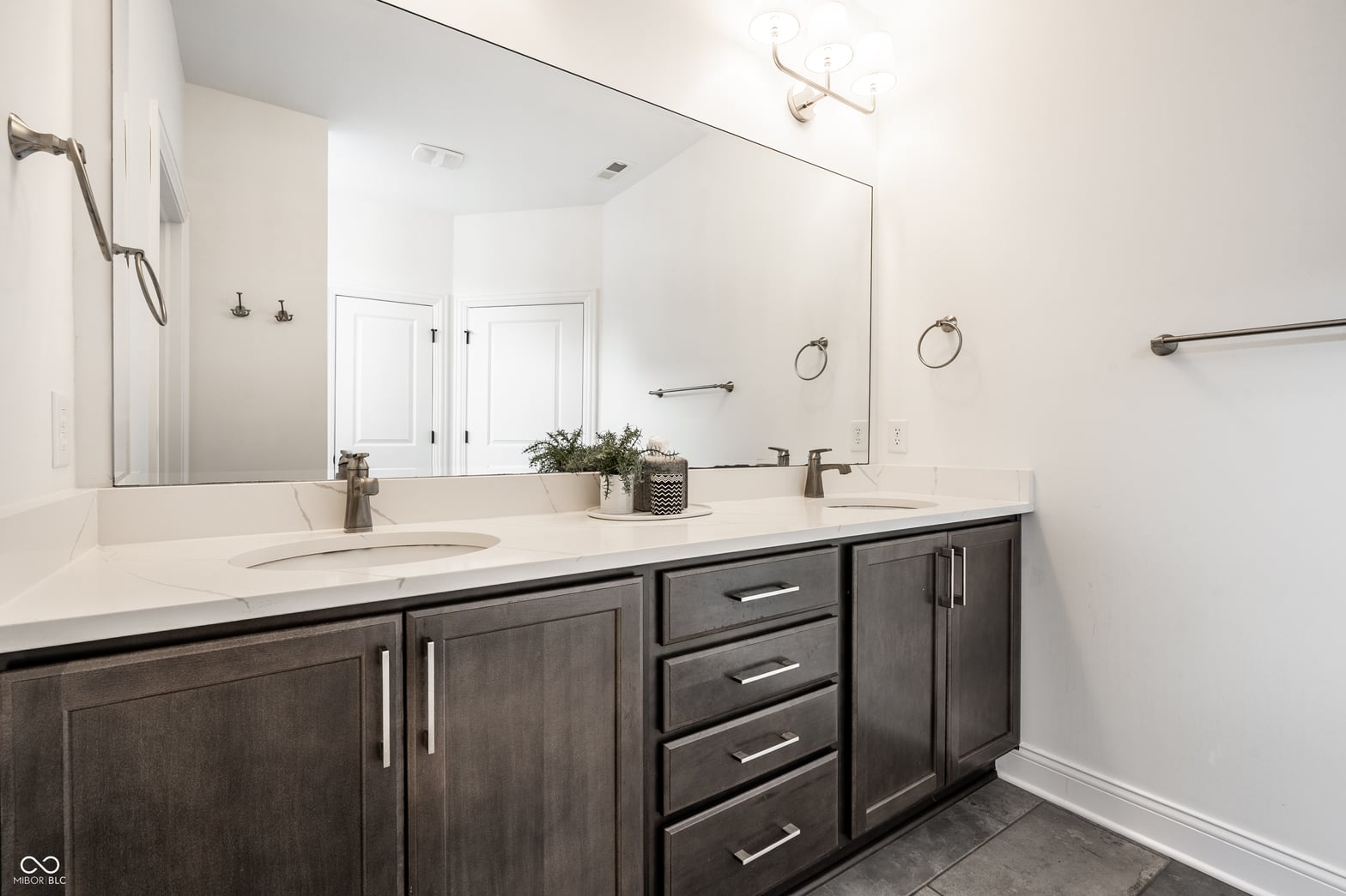 Luxurious primary bath with double vanity and frameless mirror.