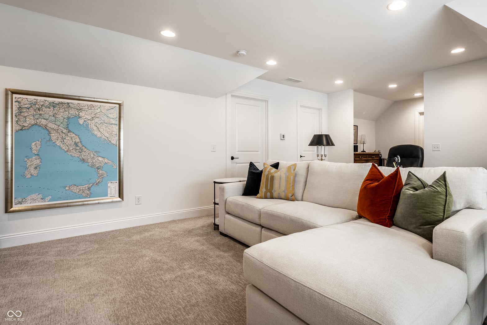 Bright family room with modern sectional and accent lighting.