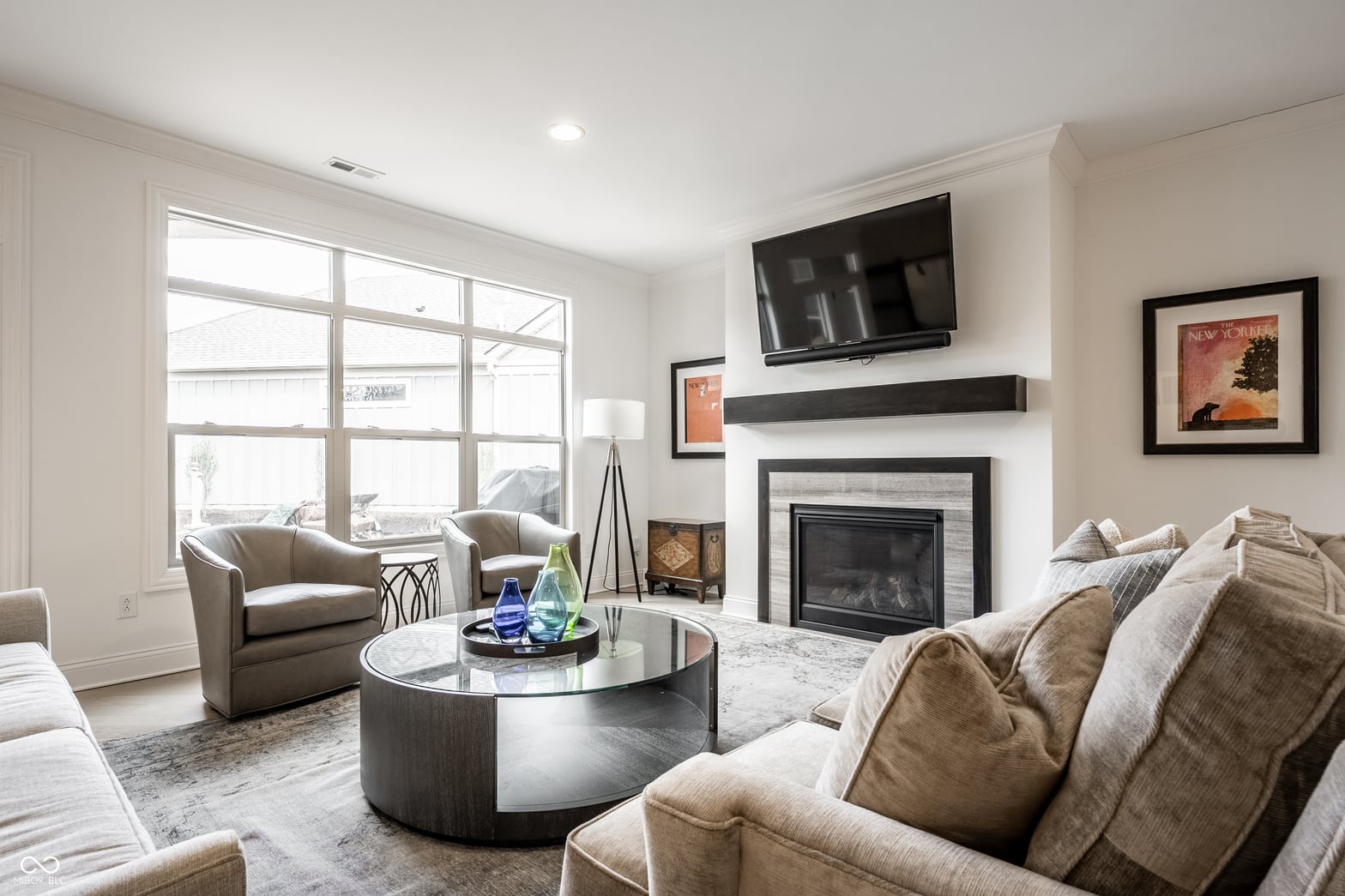 Bright living room with fireplace and entertainment setup.