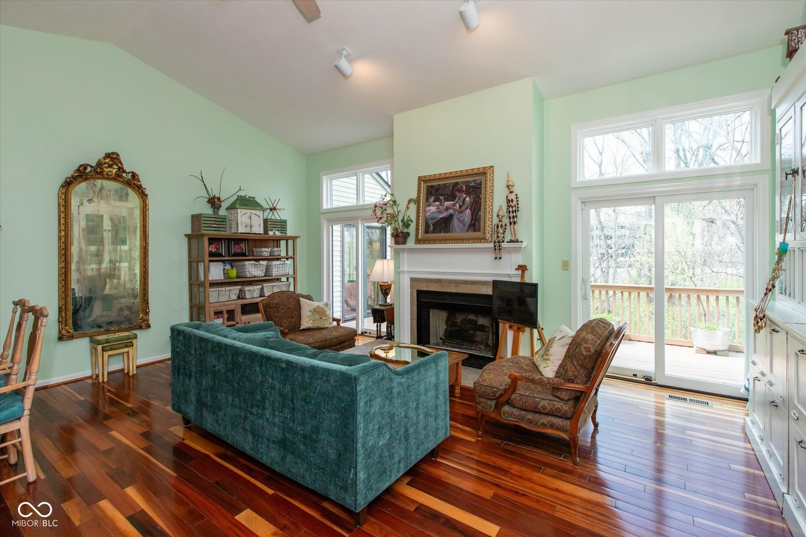 Bright traditional living room with fireplace and French doors.