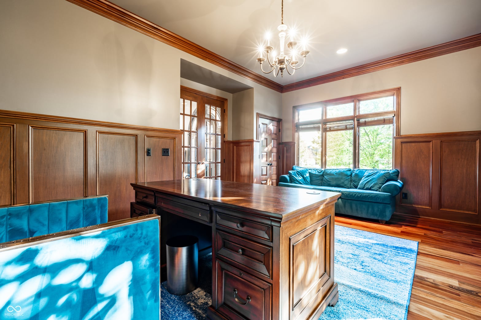 Elegant traditional family room with rich wood details and natural light.