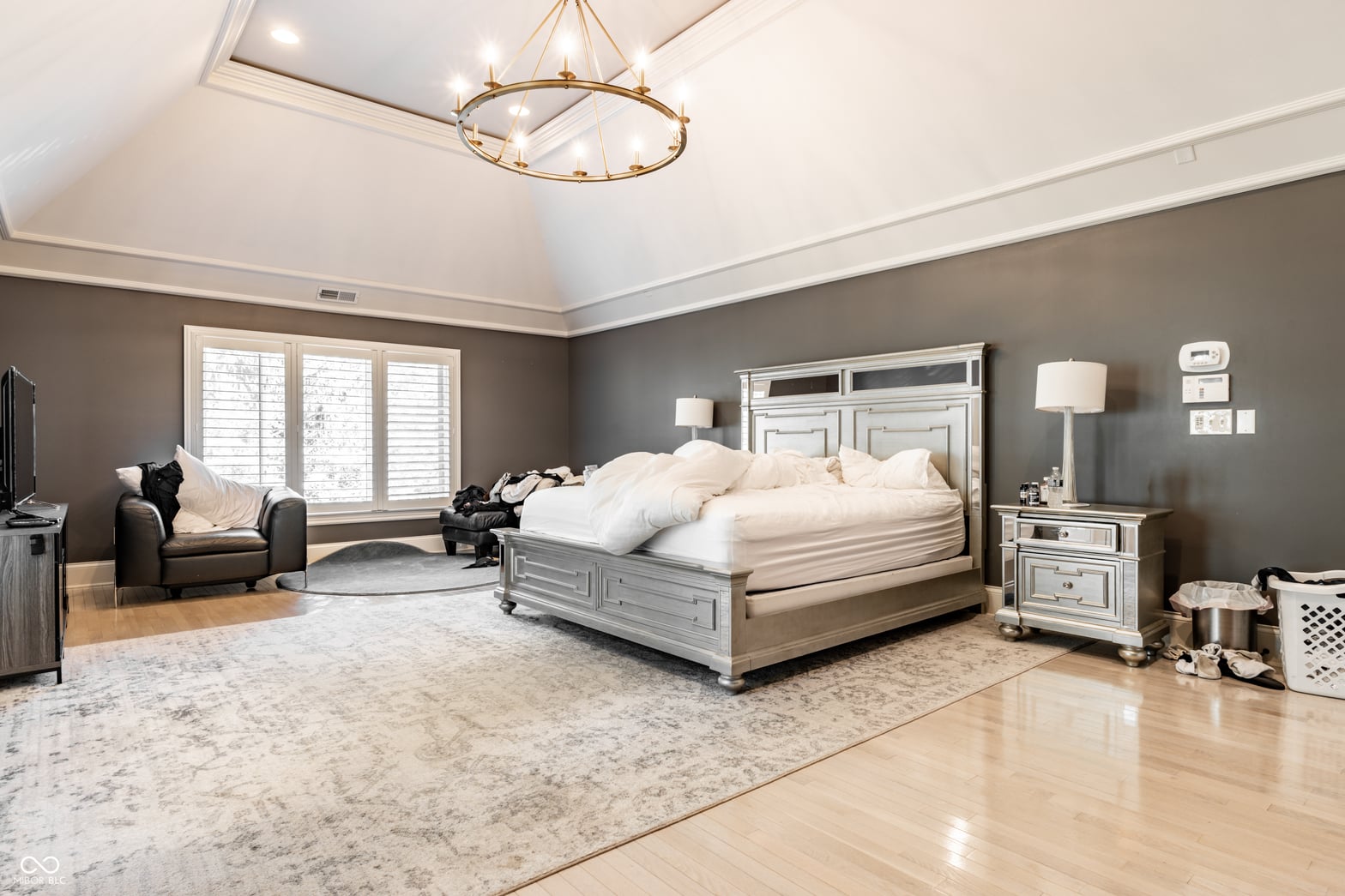 Luxurious primary suite with sitting area and elegant finishes.