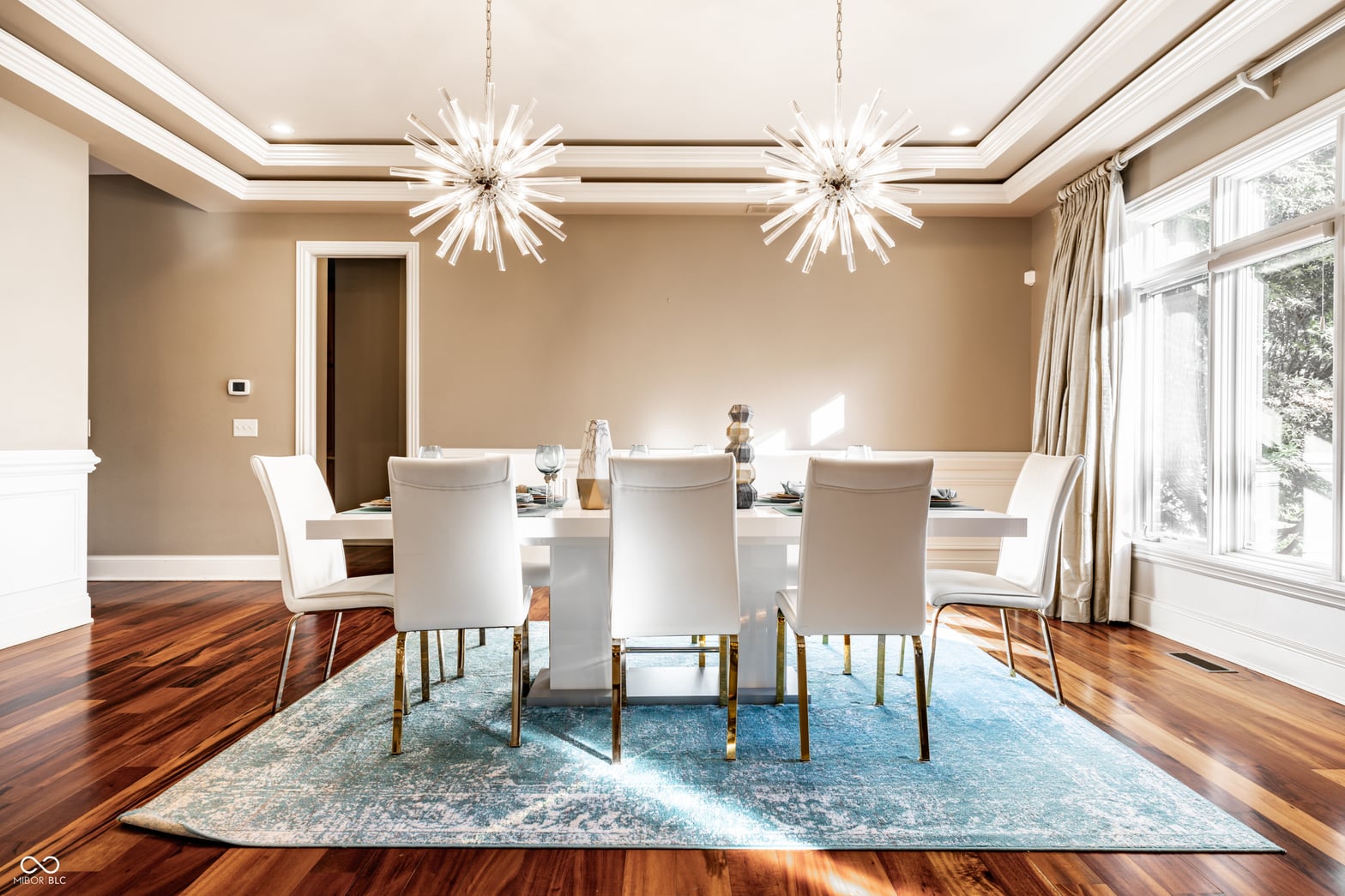 Elegant dining room with coffered ceiling and hardwood floors.