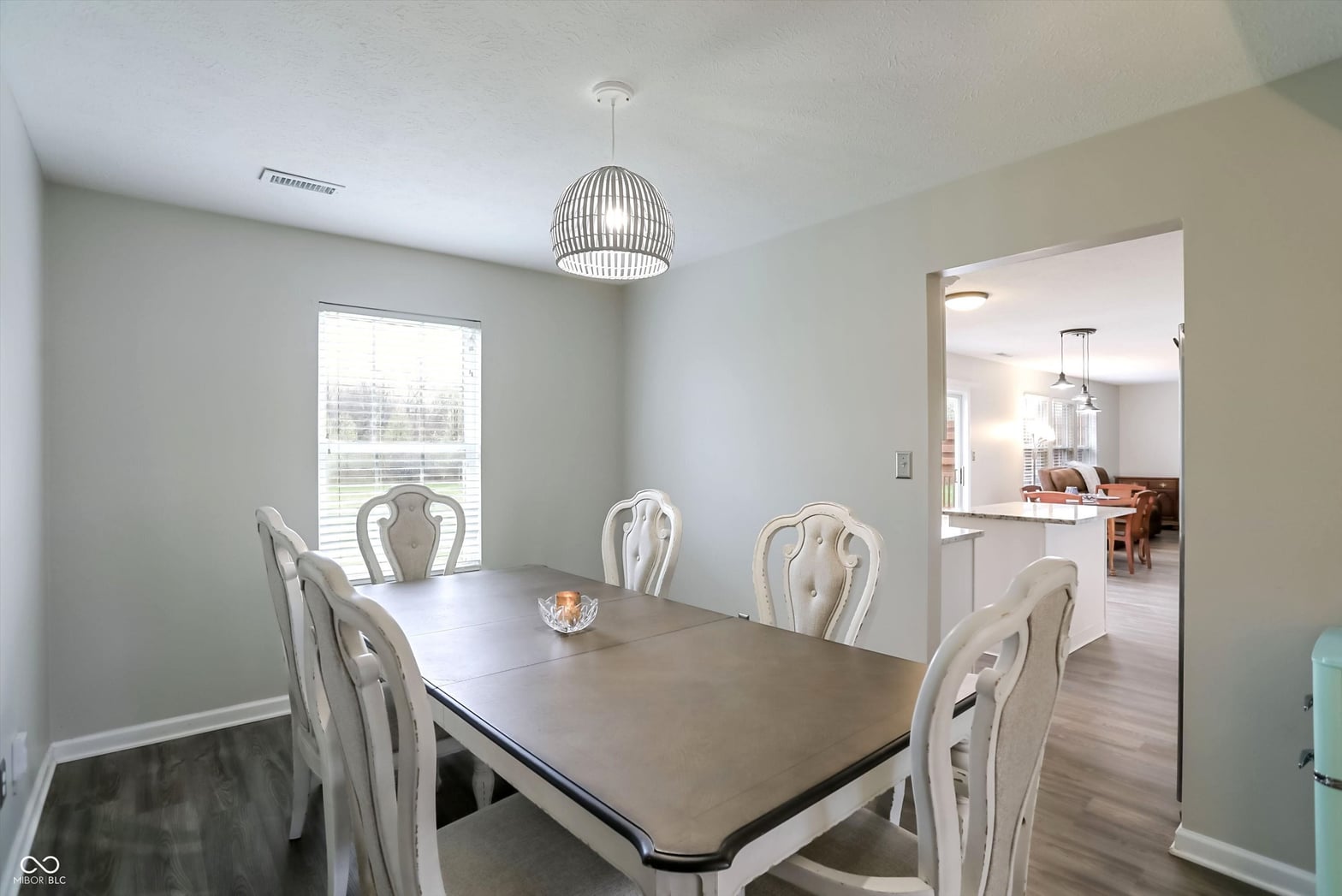 Bright dining area with modern pendant light and open layout.