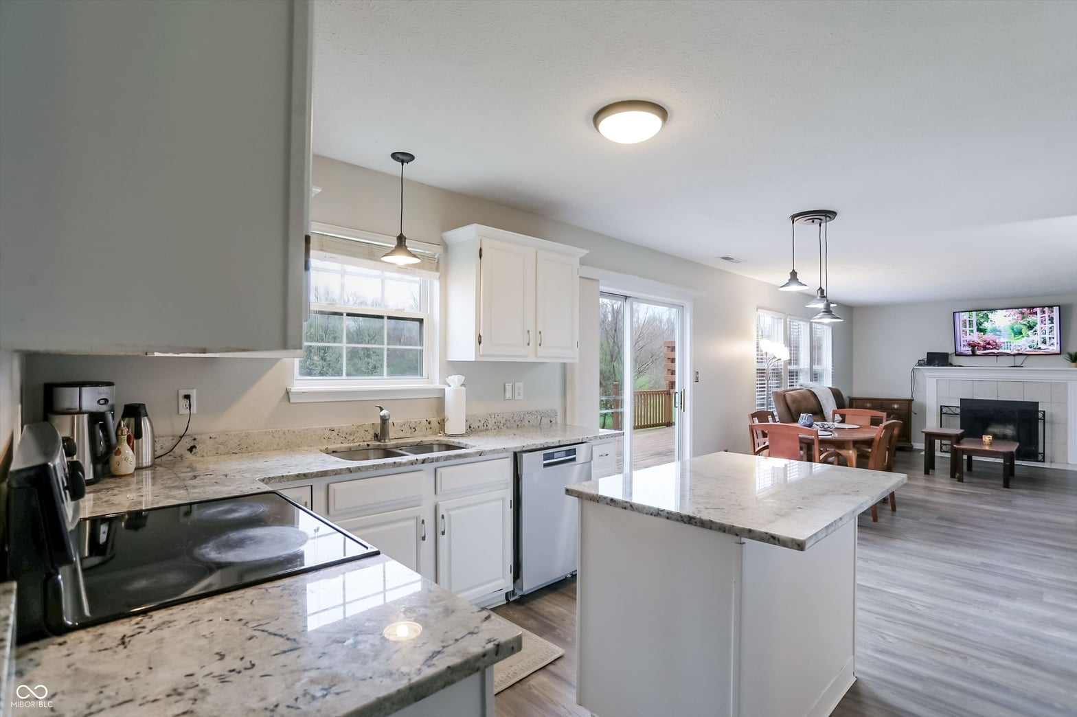 Bright open kitchen with granite island and modern finishes.