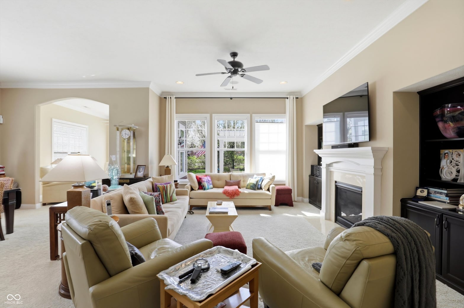 Spacious living room with fireplace and abundant natural light.