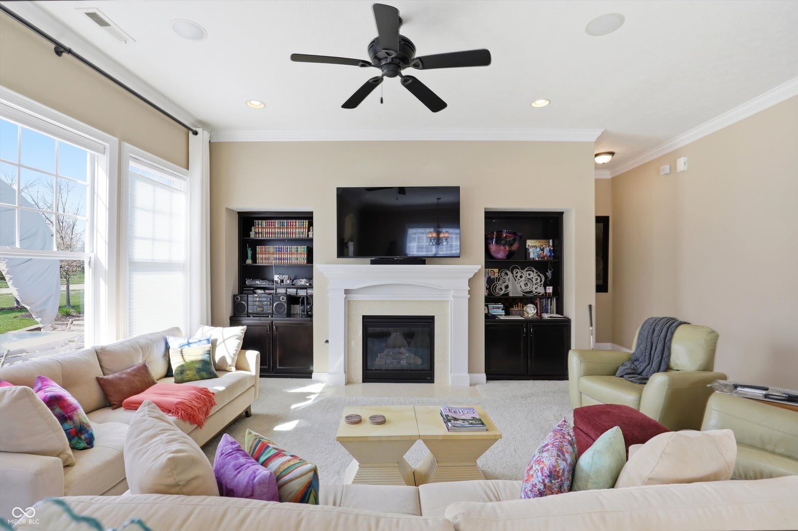 Spacious family room with fireplace and built-in entertainment center.