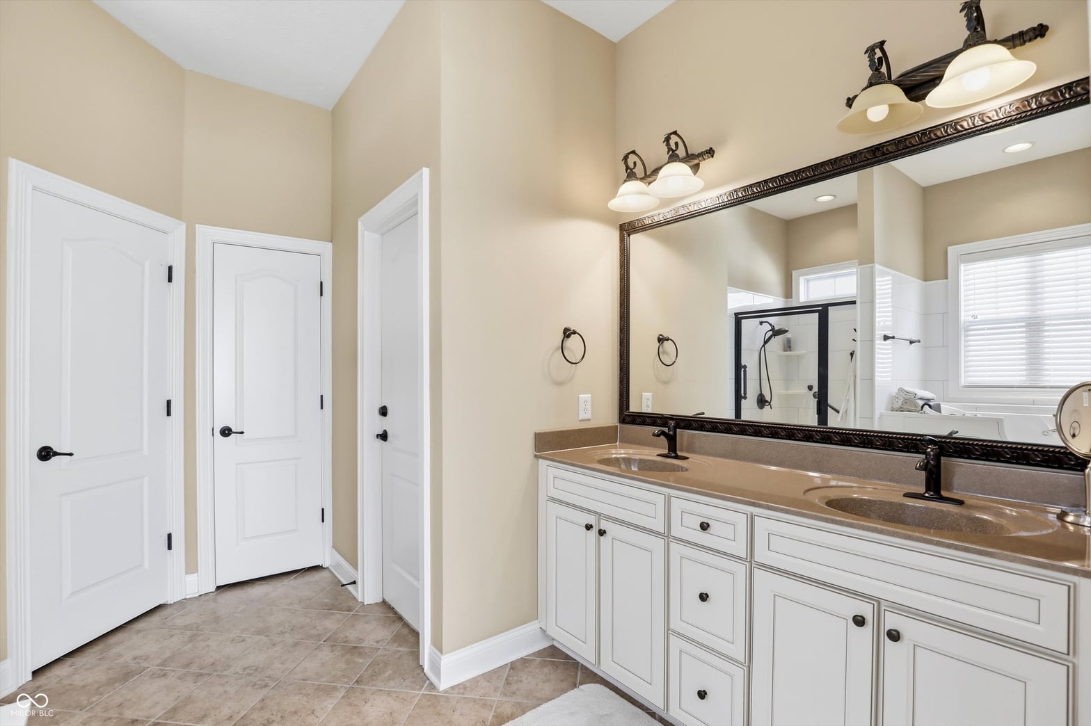 Spacious primary bath with elegant double vanity setup.