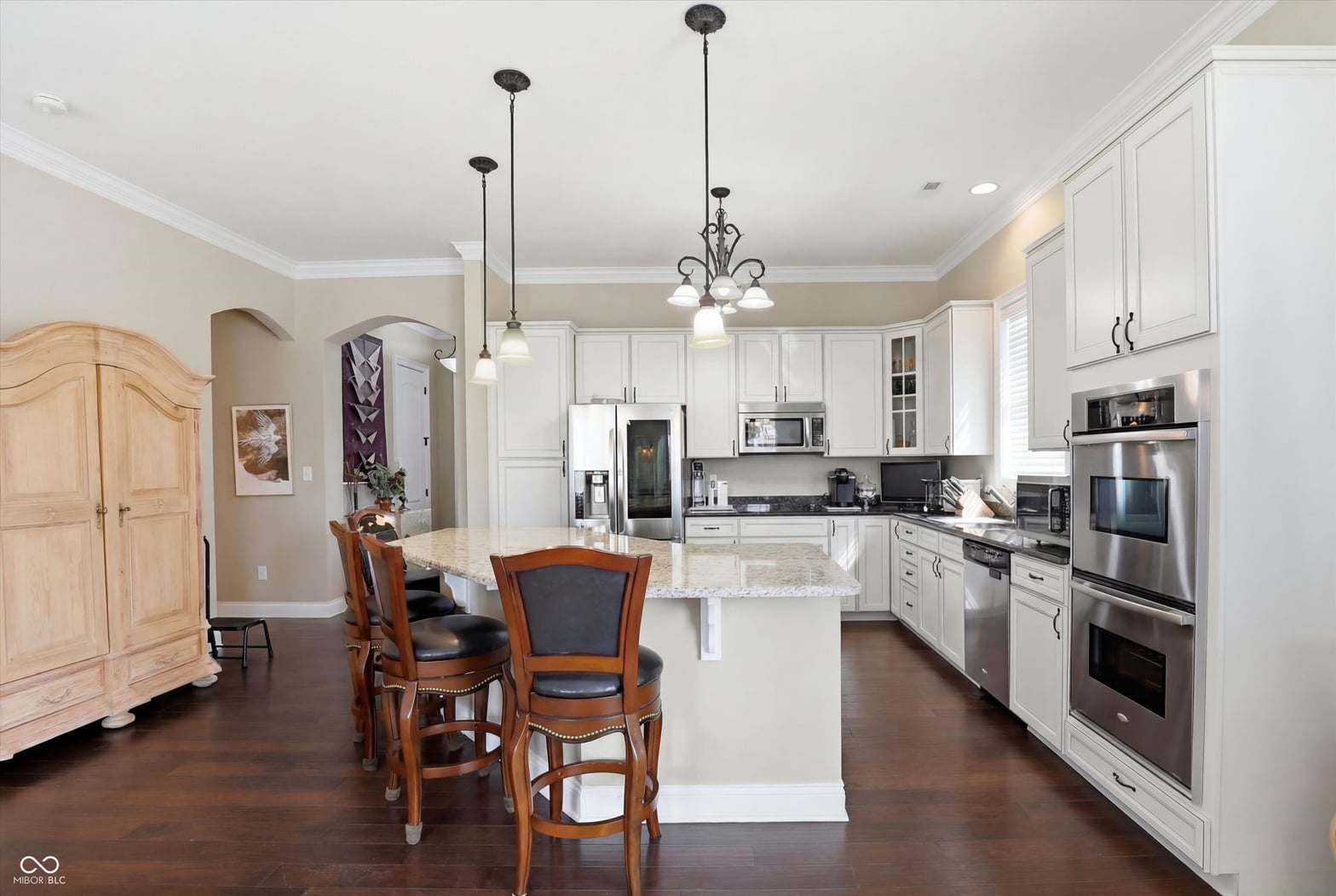 Elegant kitchen with granite island and premium stainless appliances.