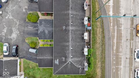 Front exterior at 6047 Southbay Drive, Indianapolis, IN — Aerial view of established townhome with mature landscaping.