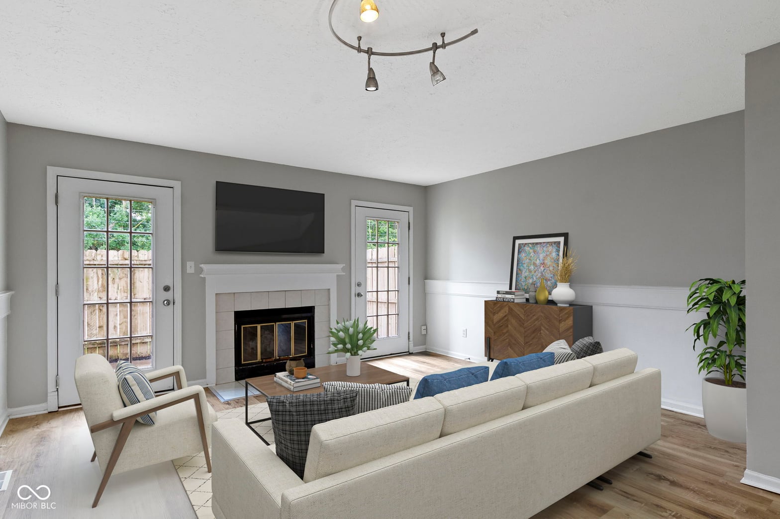 Living room at 6047 Southbay Drive, Indianapolis, IN — Bright living room with fireplace and French doors.