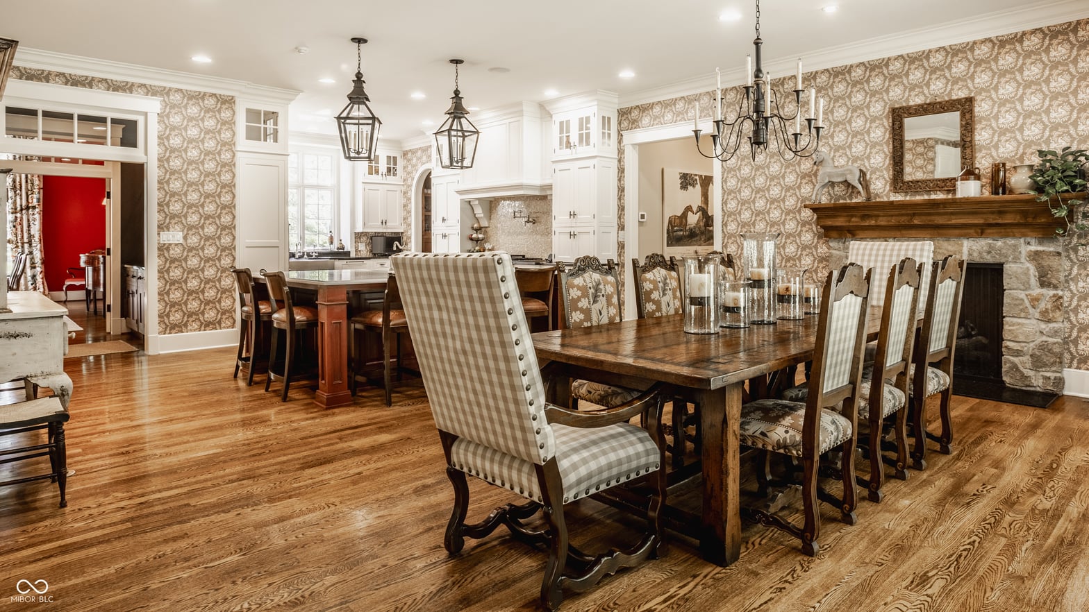 Elegant traditional dining with fireplace and open kitchen flow.