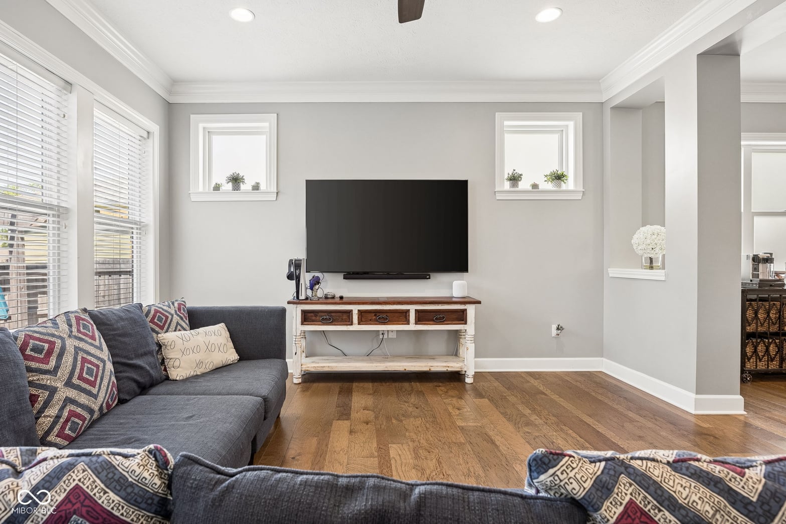 Bright family room with hardwood floors and custom built-ins.