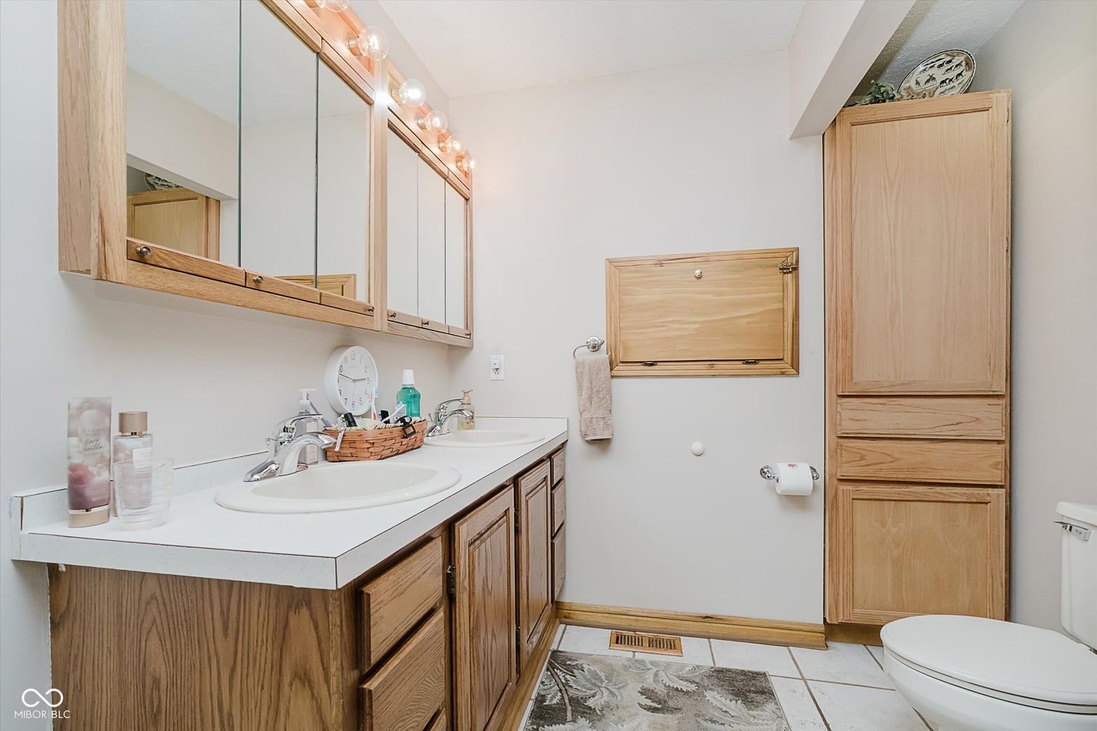 Primary bathroom at 2628 Inlet Drive, Cicero, IN — Spacious primary bath with wood cabinetry and ample storage.