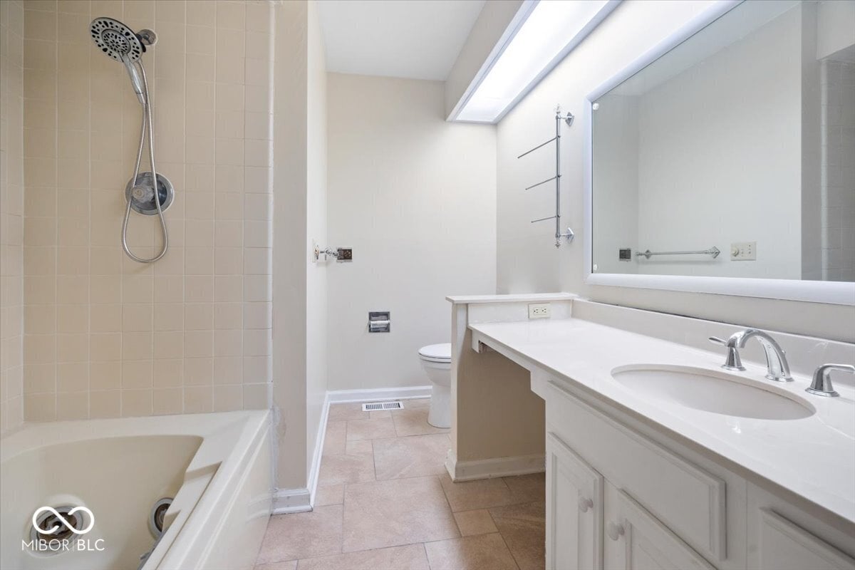 Spacious primary bath with dual vanity and modern shower.