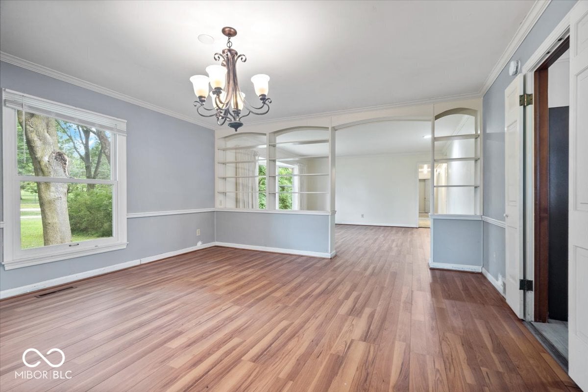 Bright transitional living room with gleaming hardwood floors.