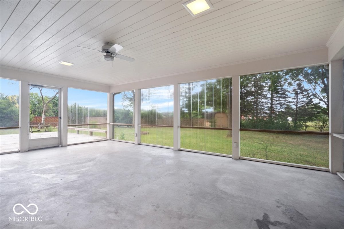 Bright screened porch with panoramic yard views.