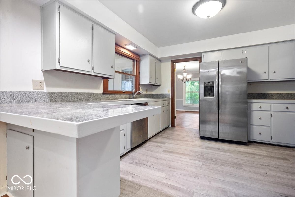 Spacious renovated kitchen with granite counters and stainless appliances.