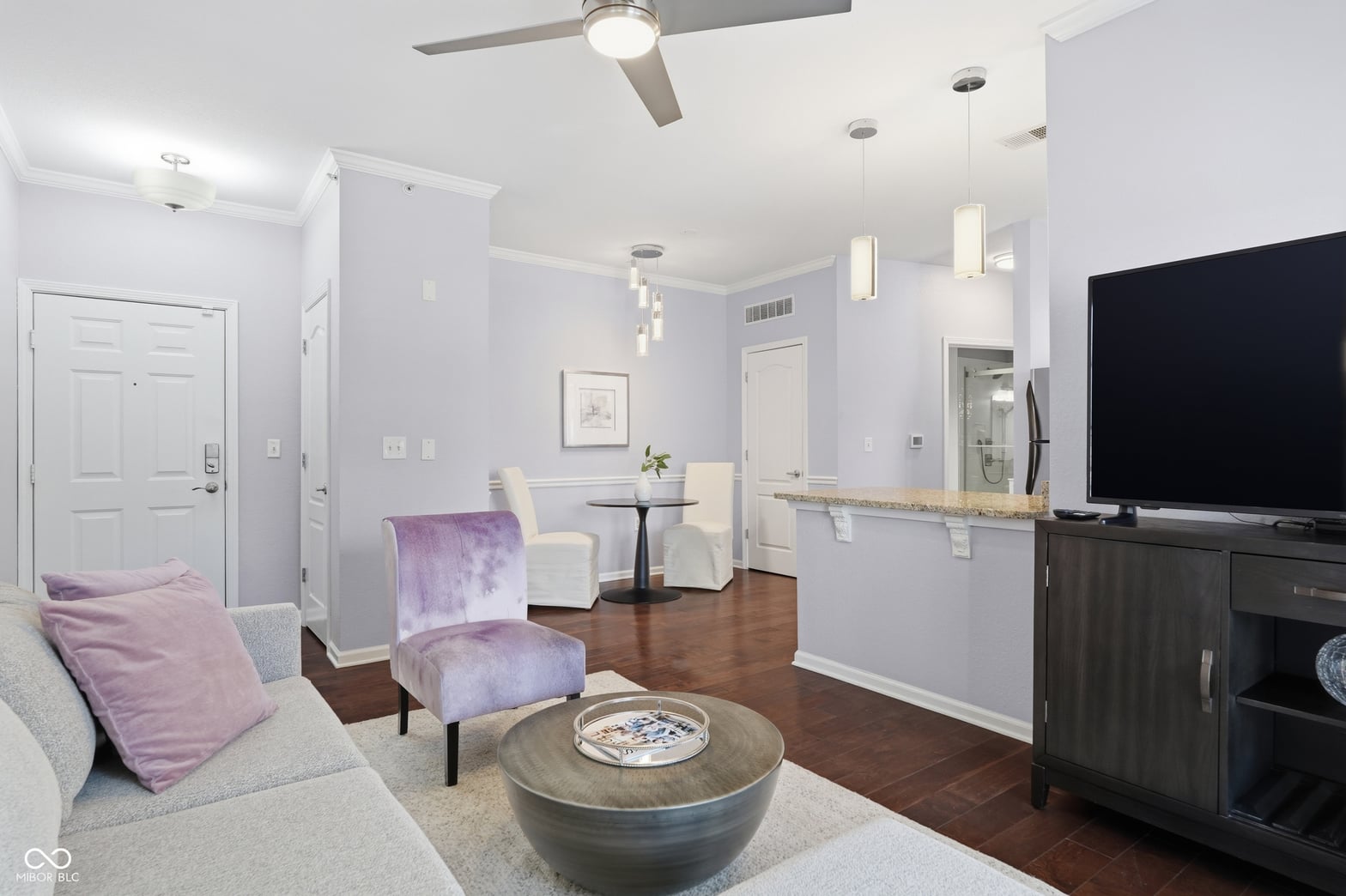 Bright contemporary family room with hardwood floors and modern fixtures.