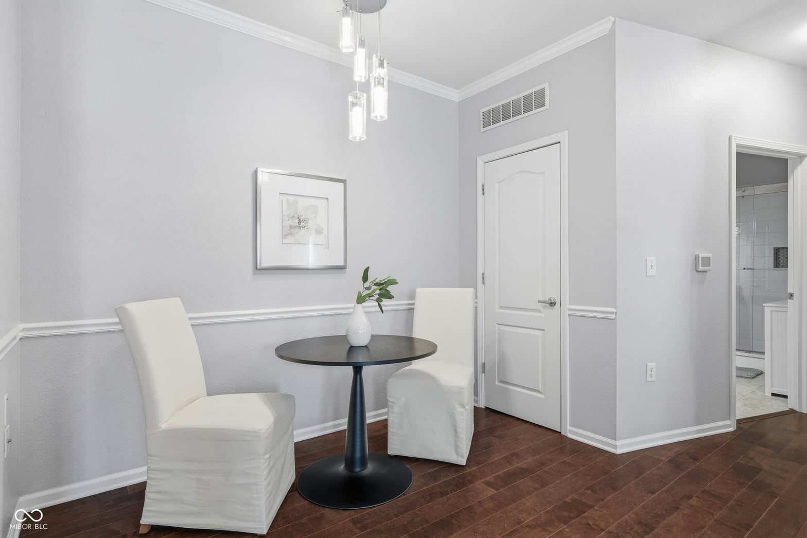 Elegant primary bathroom with wainscoting and modern amenities.
