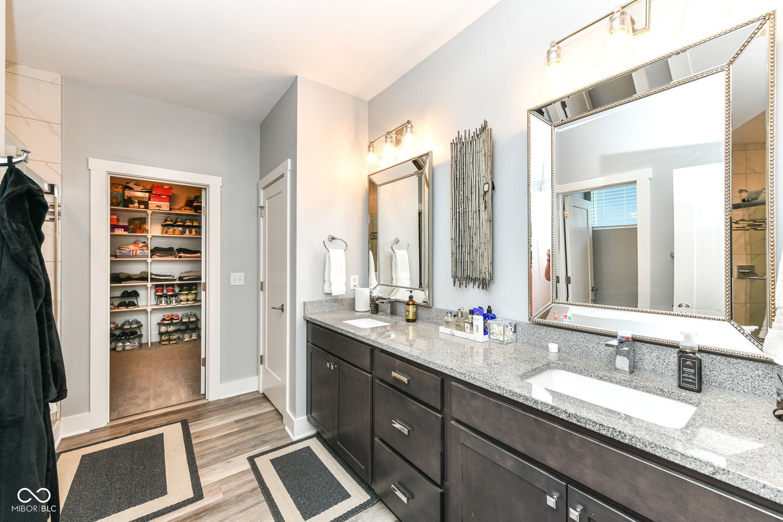 Luxurious primary bath with double vanity and walk-in closet.