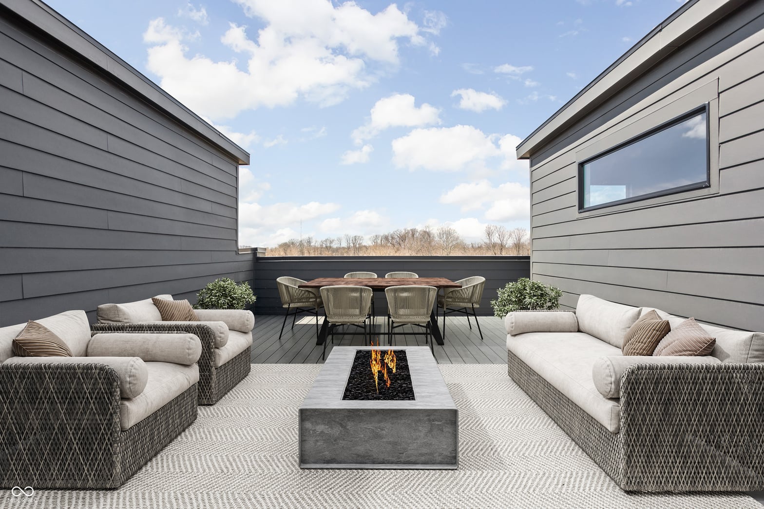 Expansive modern deck with fire pit and dining.