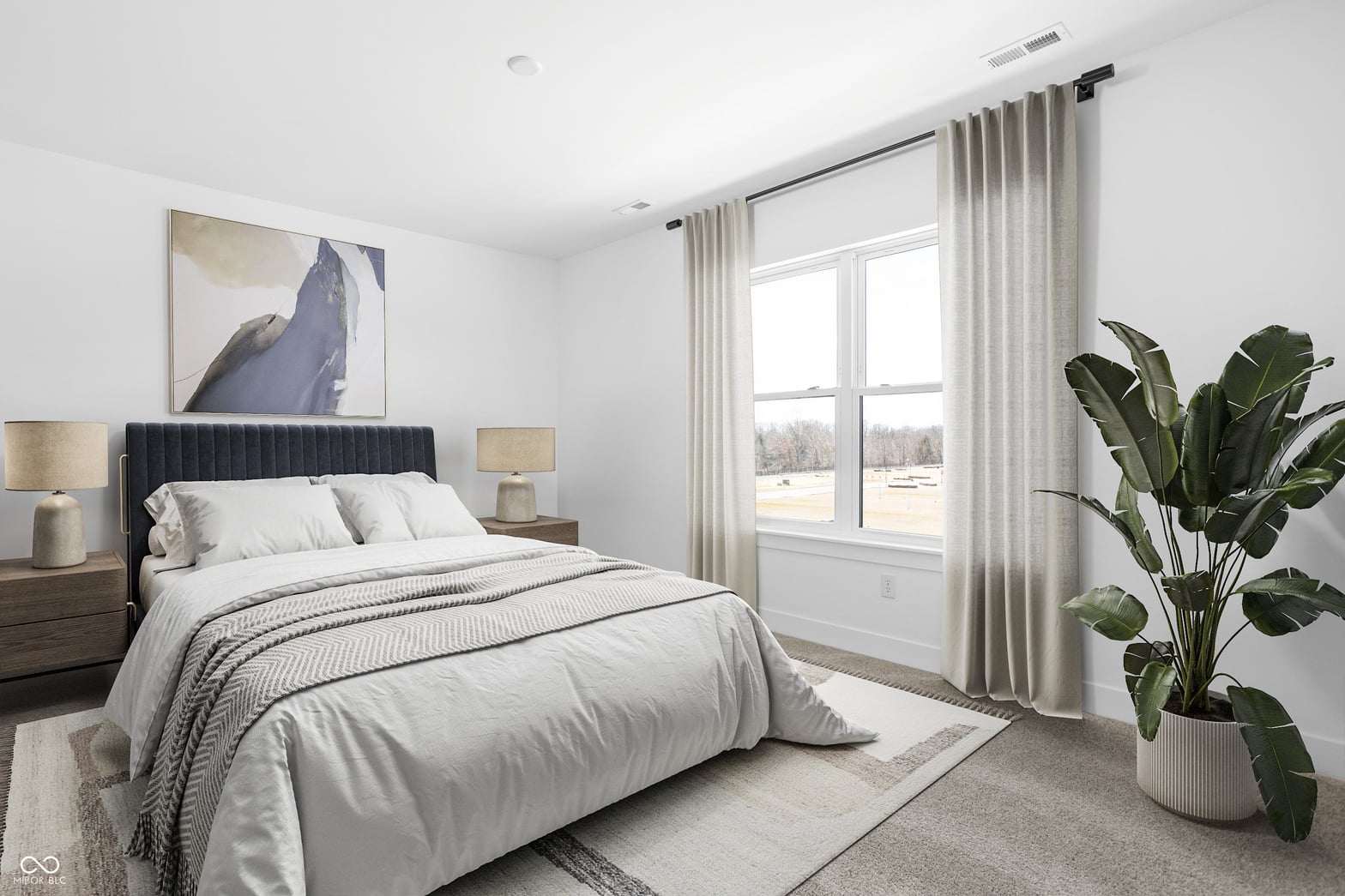 Bright primary bedroom with sliding glass doors and modern finishes.