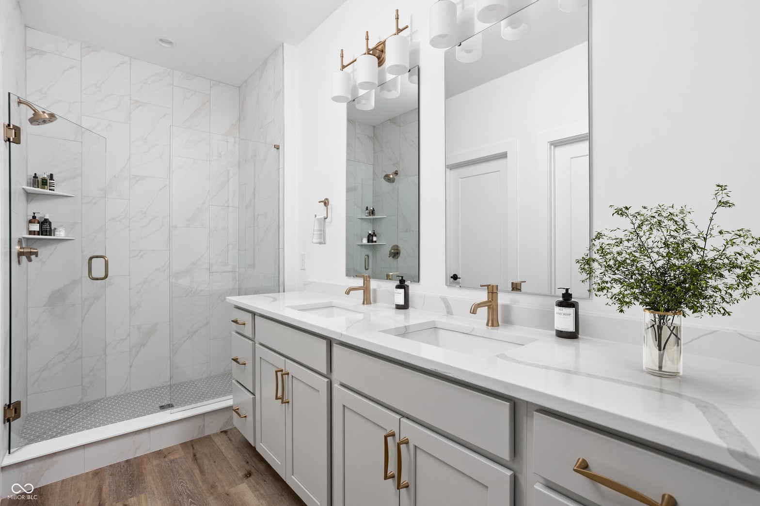 Luxurious primary bath with marble finishes and dual vanity