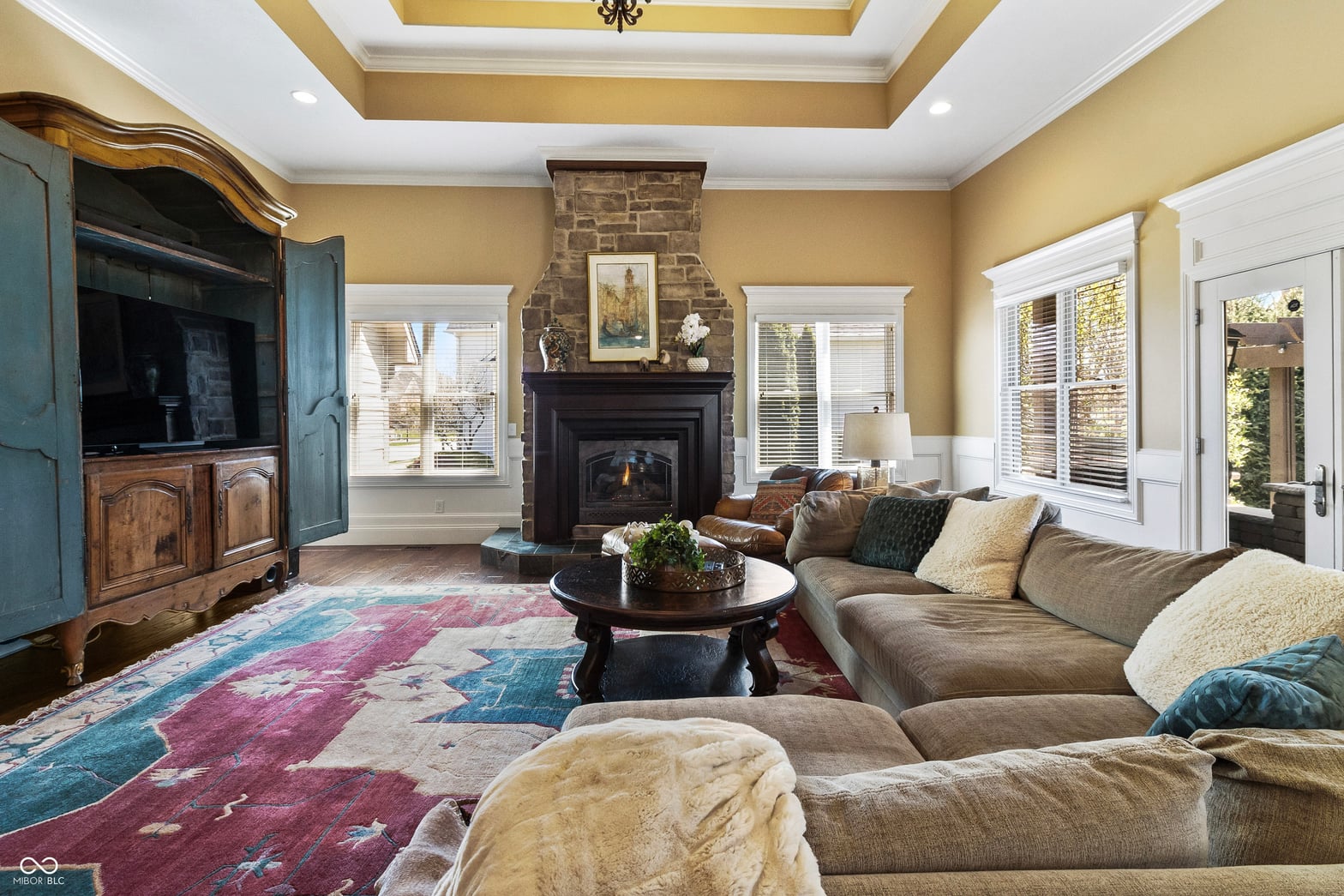 Elegant family room with fireplace and abundant natural light.