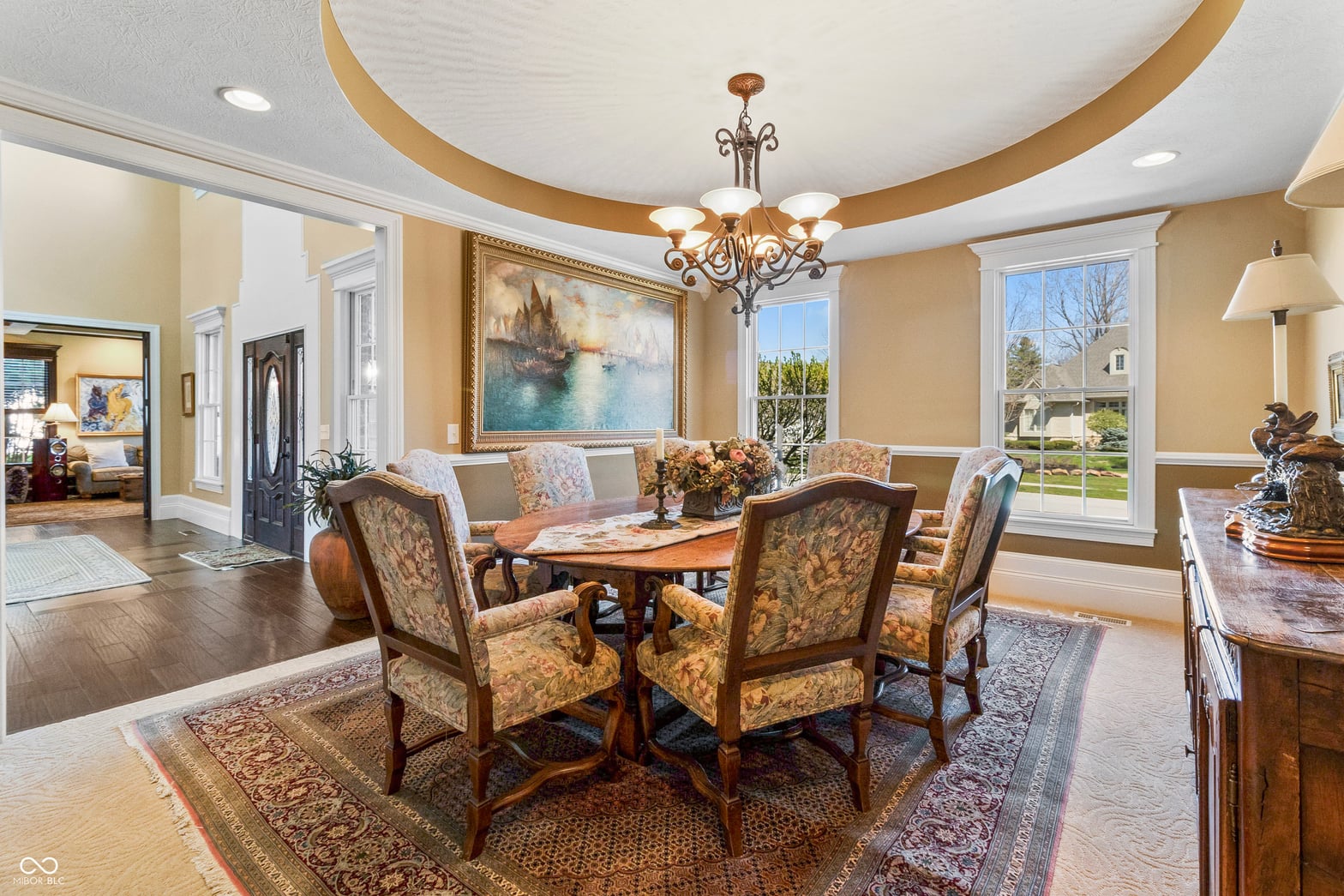 Elegant curved ceiling with ornate chandelier and abundant natural light.
