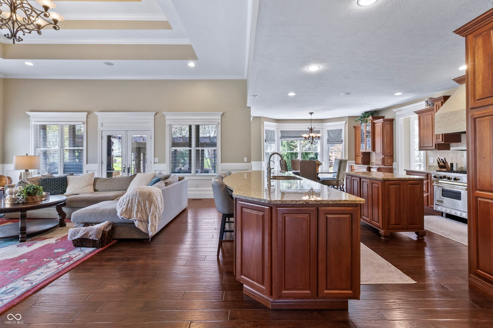 Spacious kitchen with granite island opens to living areas.