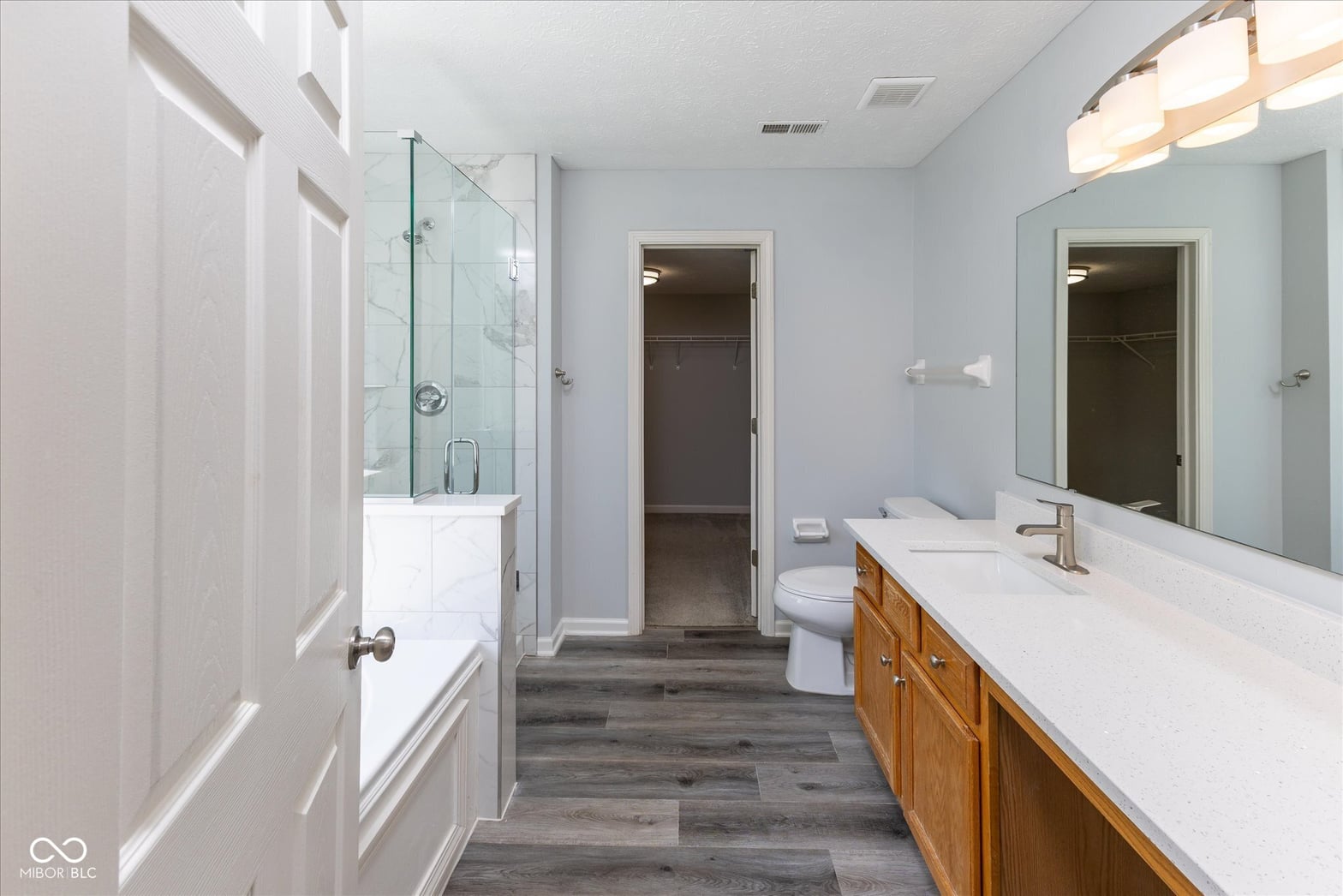 Luxurious primary bath with dual vanity and spa shower.
