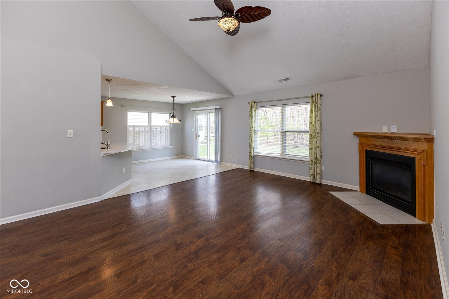 Spacious family room with hardwood floors and fireplace.
