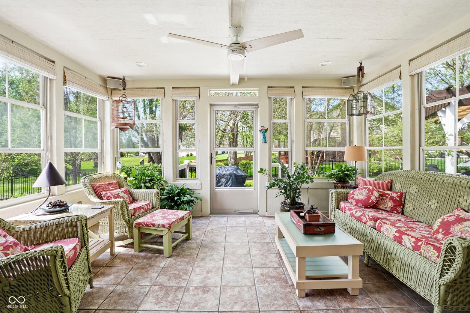 Bright screened porch with French doors and garden views.