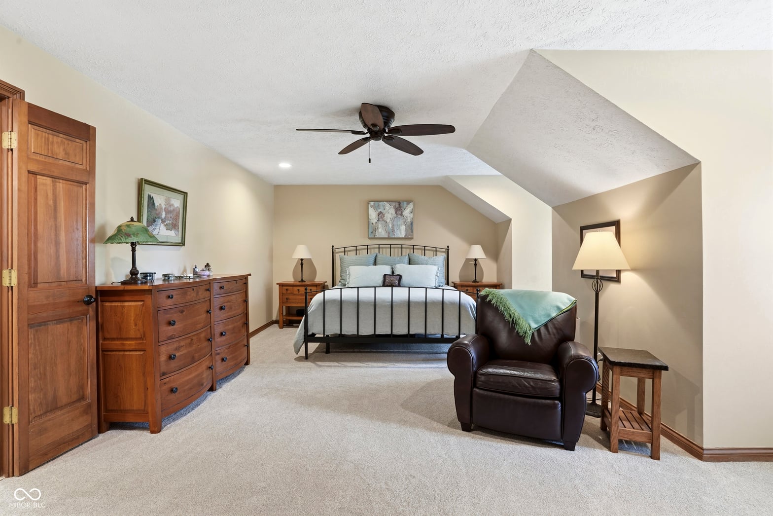 Spacious primary bedroom with vaulted ceilings and skylights.