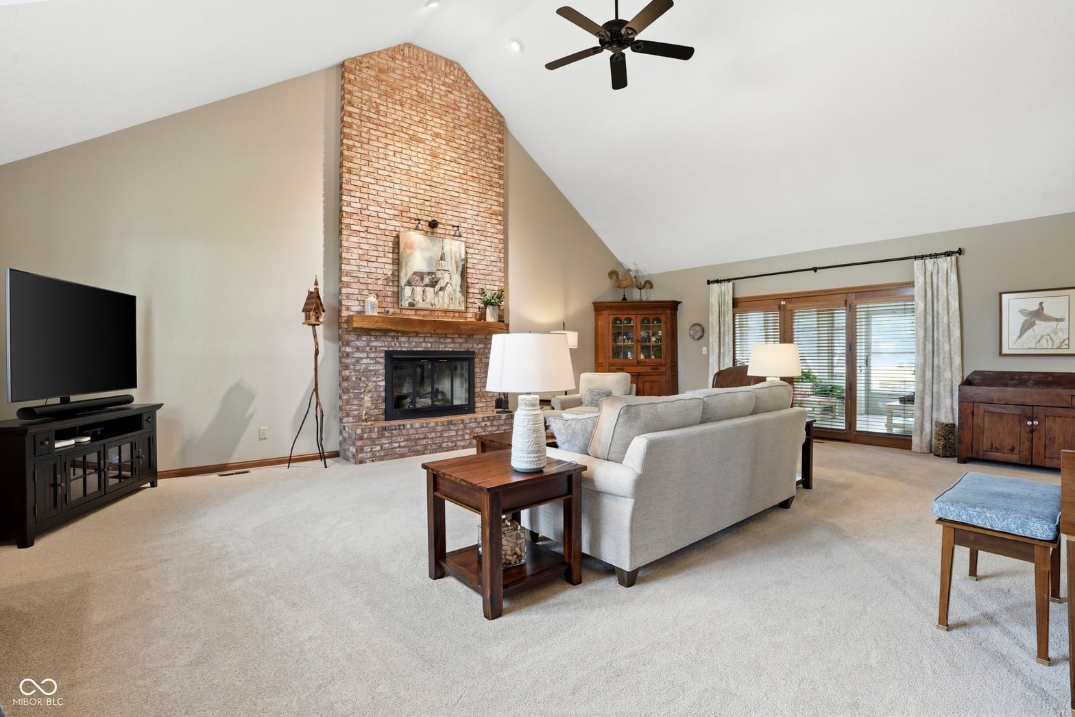 Spacious family room with soaring vaulted ceilings and fireplace.