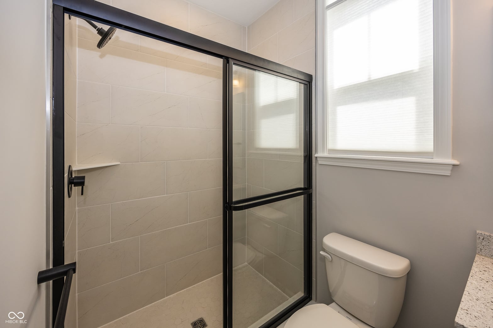 Modern primary bath with spacious walk-in shower.